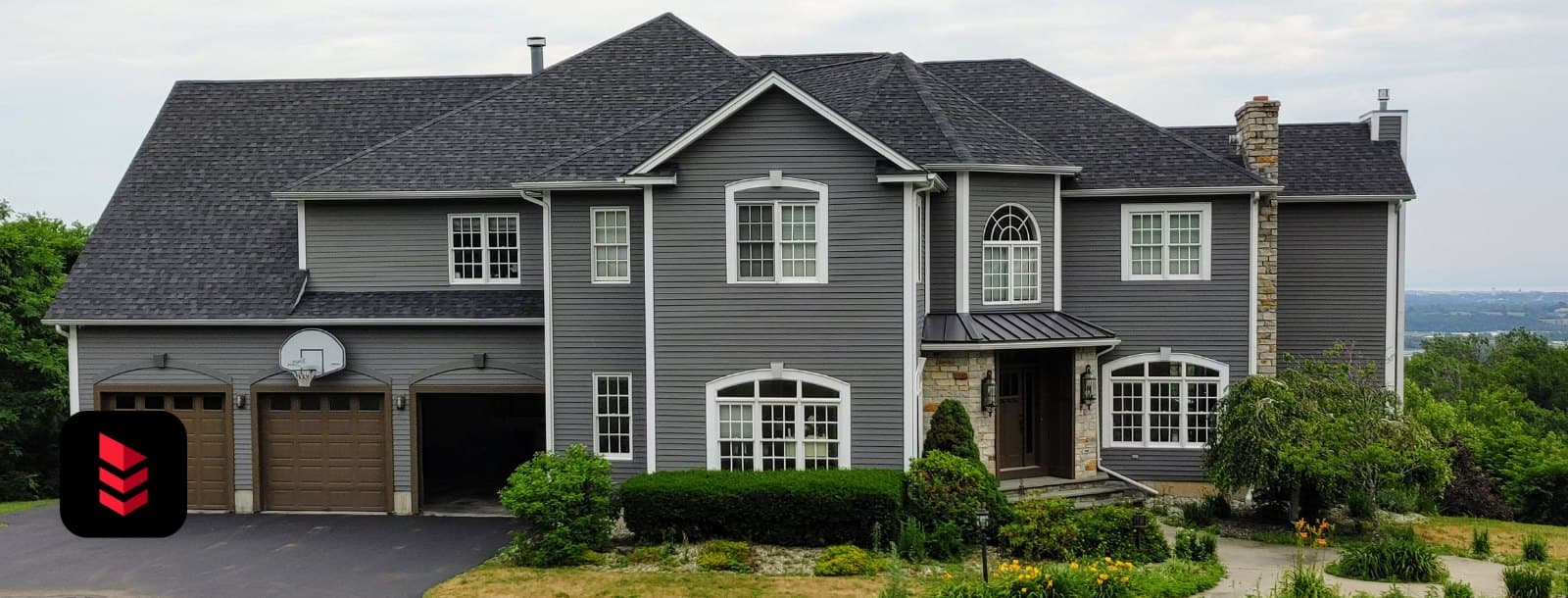 Large grey home with a new IKO Dynasty Granite Black shingle roof