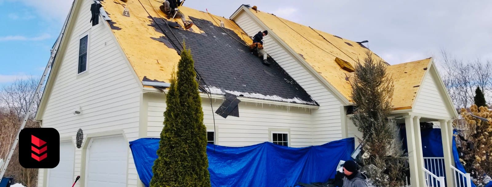Crew part-way through a winter tear-off with the underlayment exposed